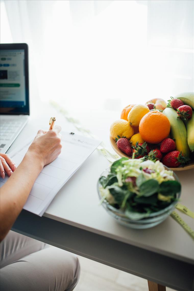 Meal planning with fresh fruits and salad on a bright kitchen table