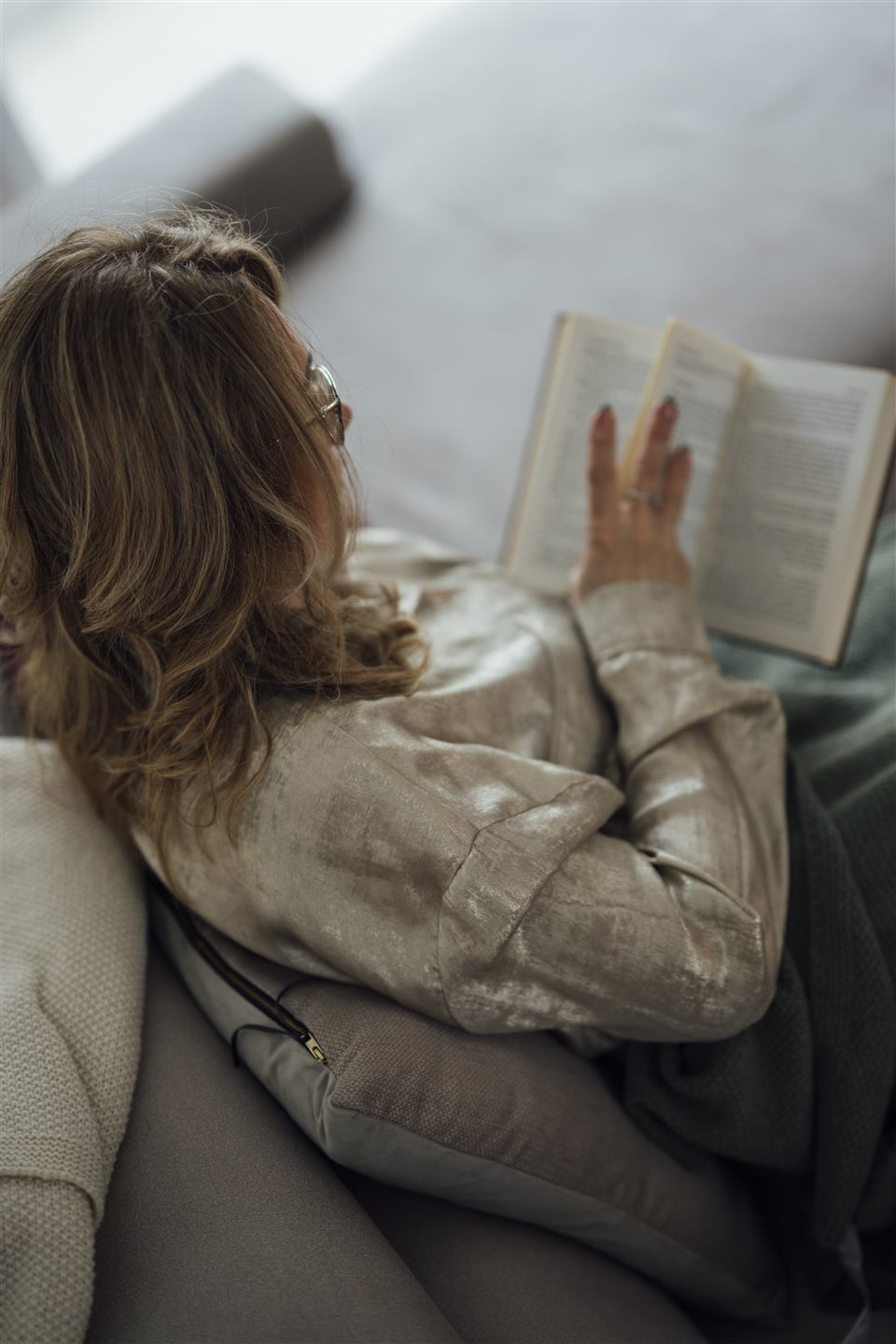 Woman relaxing comfortably at home with a warm drink